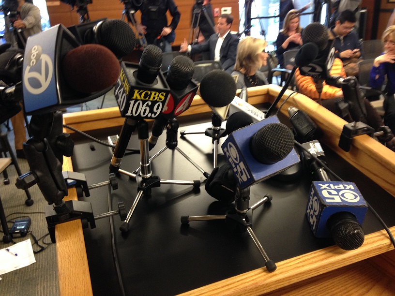 image of broadcast media microphones at podium