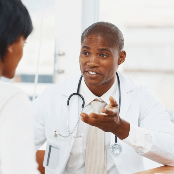 Doctor in lab coat talking to patient